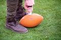 Man pumping air into american football ball