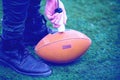 Man pumping air into american football ball