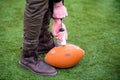Man pumping air into american football ball