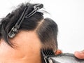 Close up shot of man getting trendy haircut. Male hairstylist serving client, making haircut using machine and comb. the concept