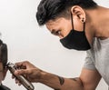 Close up shot of man getting trendy haircut. Male hairstylist serving client, making haircut using machine and comb. the concept