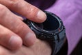 Close up shot of a man hand that uses a smart watch to view incoming messages and calls