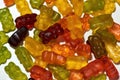 Close up shot of many tasty colorful gummy bears made from fruit juice, gelatin and sugar isolated over white background