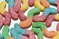 Close up shot of many tasty colorful sour sugar coated gummy worms isolated over white background Royalty Free Stock Photo