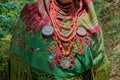 Close-up shot of a Maragato elderly woman in a traditional green Castilla y Leon costume and jewelry