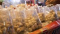 Close up shot of packed meat balls in Asia food market surrounded by flies