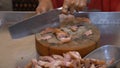 Close up shot of woman in Asia market cutting raw meat