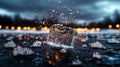 A close-up shot of a melting ice cube splashing on a wet surface at dusk, with blurred bokeh lights in the background.