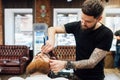 Man getting trendy haircut at barber shop.