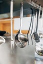 Metallic utensils hanging at kitchen of restaurant Royalty Free Stock Photo