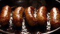 Close up shot of mild Italian sausages cooking in skillet. Slow motion of sausage with steam and oil popping in pan. Meat dinner b Royalty Free Stock Photo