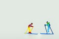 Close-up shot of miniature figurines of skiers isolated on a white background