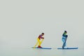 Close-up shot of miniature figurines of skiers isolated on a white background