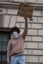 UK, London, 6/6/2020 -A close up shot of a mixed race Black Lives Matter protester waving an anti-racism placard