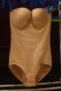 Close-up shot of the modern classic sexy beige seamless smooth luxury elegant women push up bodysuit.