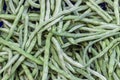 Close-up shot for multiple green colored string beans on plastic box