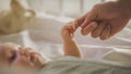 Close Up Shot of Newborn Baby Playing With Mother's Hand and Finger while Lying on the Back in Royalty Free Stock Photo