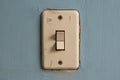 Old and dirty light switch on a blue wall Royalty Free Stock Photo