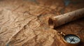 A close-up shot of an old, weathered map with a rolled parchment and compass Royalty Free Stock Photo