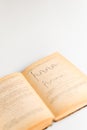 Close up shot of an open old science book containing equations and graphs from different fields: math, physics, chemistry. The