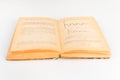 Close up shot of an open old science book containing equations and graphs from different fields: math, physics, chemistry. The