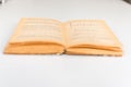Close up shot of an open old science book containing equations and graphs from different fields: math, physics, chemistry. The