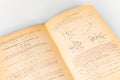 Close up shot of an open old science book containing equations and graphs from different fields: math, physics, chemistry. The