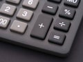 A close up shot of the operator buttons of a calculator