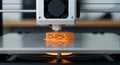 Close Up of Orange Filament 3D Printer Creating Lattice Object on Gray Platform In Studio with Blur Background Royalty Free Stock Photo