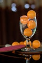 Close-up shot of orange ping pong in clear glass. Royalty Free Stock Photo