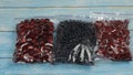 Packages with blueberry, cherry, raspberry in zipper plastic bags for freezing. Frozen berries food