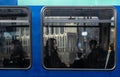 Close-up shot of passengers sitting on seats inside a train