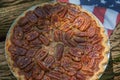 Close up shot of a pecan pie cooling. American classic homemade pecan pie. Amish pies. Napkin a flag of USA. Royalty Free Stock Photo