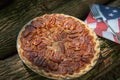 Close up shot of a pecan pie cooling. American classic homemade pecan pie. Amish pies. Napkin a flag of USA. Royalty Free Stock Photo