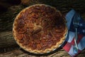 Close up shot of a pecan pie cooling. American classic homemade pecan pie. Amish pies. Napkin a flag of USA. Royalty Free Stock Photo