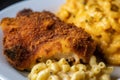 Close-up shot of a perfectly cooked and seasoned fried catfish steak with grill marks, served with a side of mac and cheese Royalty Free Stock Photo