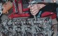 Close-up shot of a person repairing a metallic engine