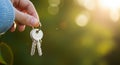Hand Holding House Keys with Bokeh Background image Royalty Free Stock Photo