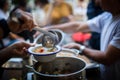 Person serving a portion of fish soup