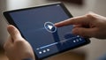 A close-up shot of a person using their finger to press the play button on a video player interface displayed on a tablet computer Royalty Free Stock Photo