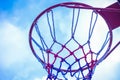 Close-up shot of a pink basketball hoop with a background of a cloudy sky