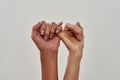 Close up shot of pinky swear. Promise hand gesture isolated over light background Royalty Free Stock Photo