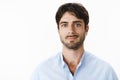 Close-up shot of pleased attractive mature guy with beard and blue eyes in shirt with unbuttoned collar smiling Royalty Free Stock Photo