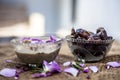 Close up shot of popular Indian & Asian winter dessert in a transparent glass bowl i.e. Khajor ka halwa or dates confection with r