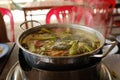 Close up shot of the pot of boiling soup on a restaurant table in Vietnam. Hot Pot.