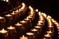 Close-up shot of prayer candles the darkness in a church Royalty Free Stock Photo