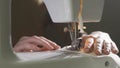 Slow motion of overcasting fabric on a sewing machine