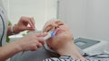 Close-up shot of Professional cosmetologist making cavitation peeling on young woman`s face