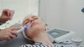 Close-up shot of Professional cosmetologist making cavitation peeling on young woman`s face