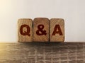 Close-up Shot of Q and A wooden blocks. Customer supprot questions and answers concept